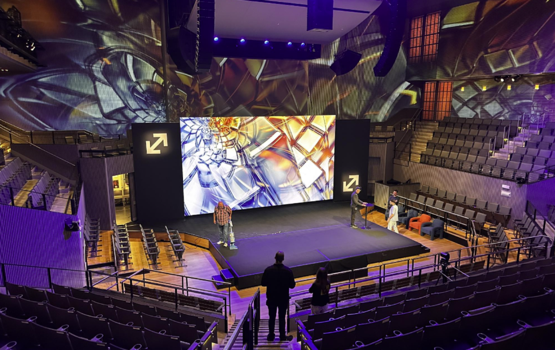 Modern concert venue with large screen stage — showtime